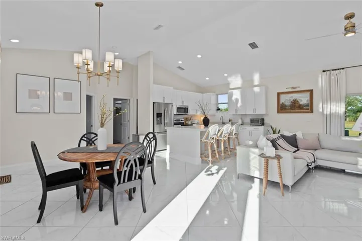 Dining space featuring marble finish floor, visible vents, and a wealth of natural light