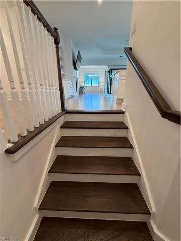 Hardwood staircase with dark wood-finish treads and white risers
