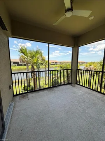 Screened balcony featuring concrete flooring