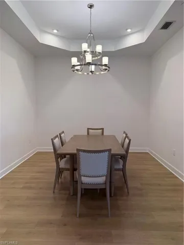 Recessed tray ceiling with accent lighting and a contemporary chandelier