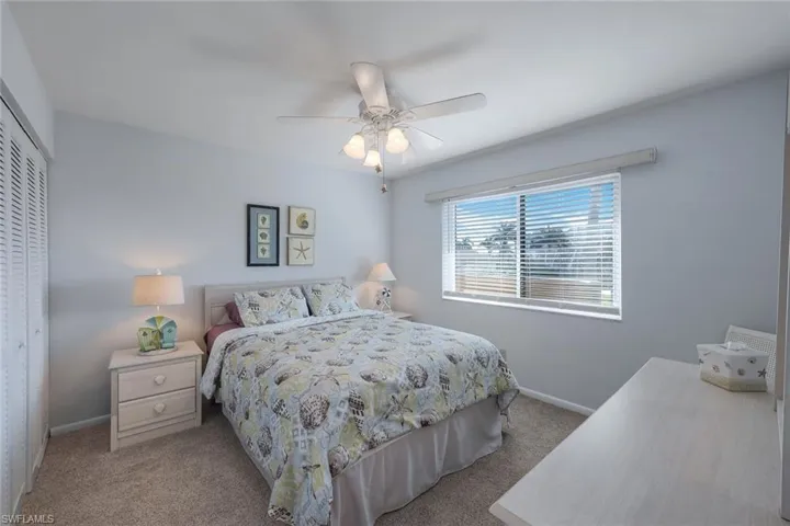 Bedroom featuring light carpet, a closet, and ceiling fan