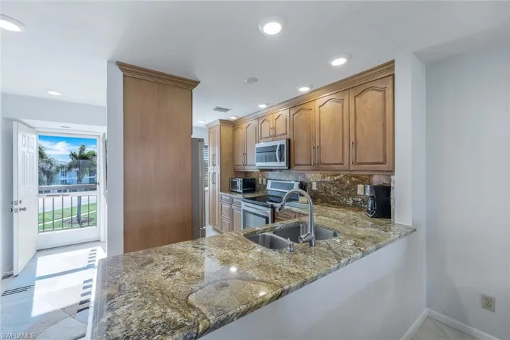 Kitchen with decorative backsplash and stainless steel appliances