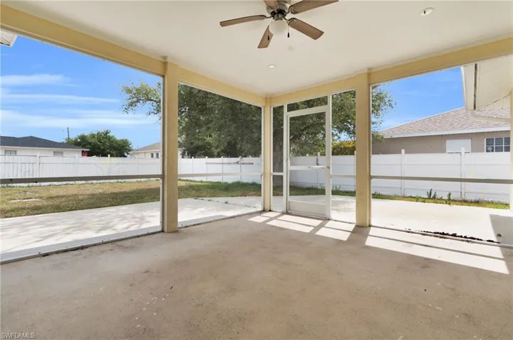 Unfurnished sunroom with ceiling fan