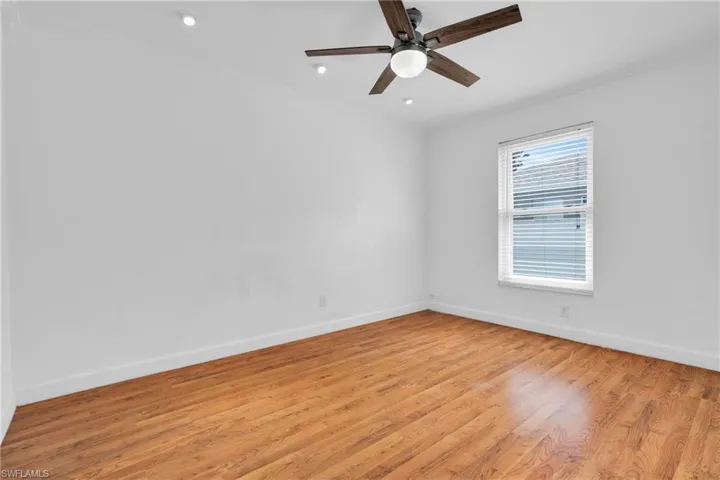 Spare room with ceiling fan, light wood-style flooring, recessed lighting, baseboards, and ornamental molding
