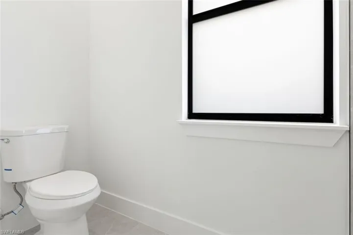 Bathroom featuring tile patterned floors and toilet
