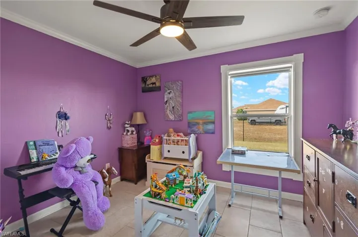 Playroom/ 2nd bedroom  with light tile floors, ceiling fan, an