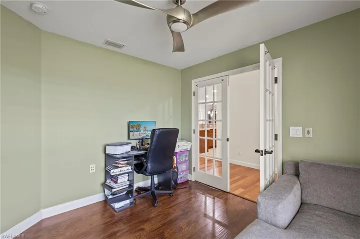 Office space or Den  featuring ceiling fan, french doors, and wood flooring