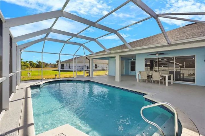 View of swimming pool with a patio, ceiling fan, and a 1/2 bathroom in the lanai!!