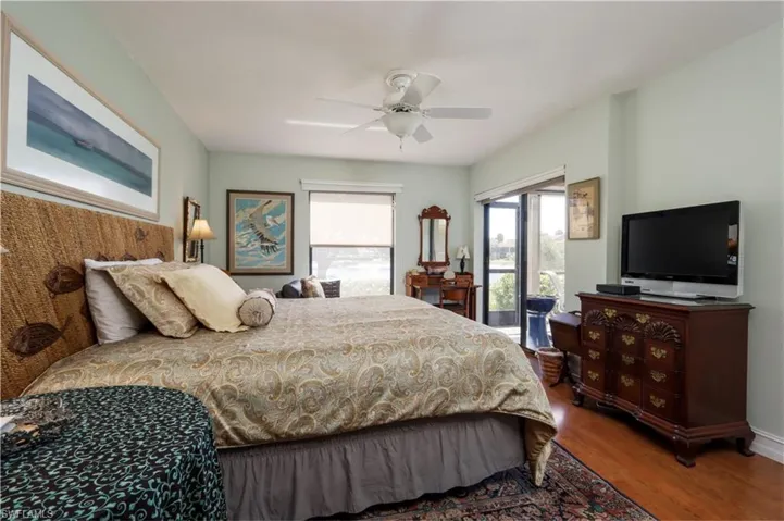 Bedroom with wood finished floors and ceiling fan