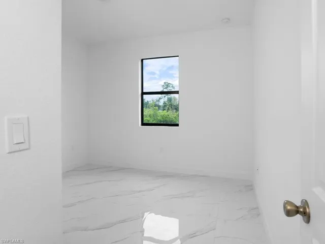 Spare room featuring light tile patterned flooring
