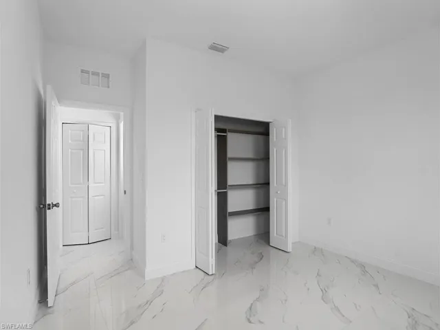 Tiled bedroom with a closet