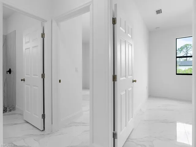 Corridor featuring light tile patterned flooring