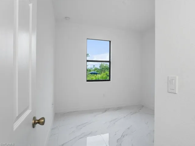 Spare room with light tile patterned floors