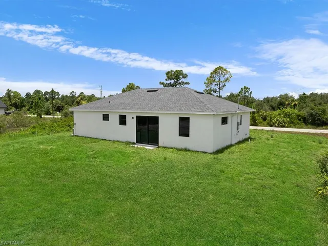 Back of house featuring a yard