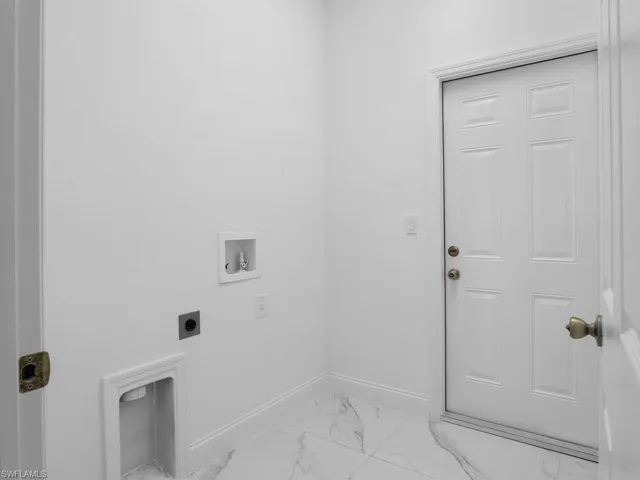 Laundry area with electric dryer hookup, tile patterned flooring, and washer hookup