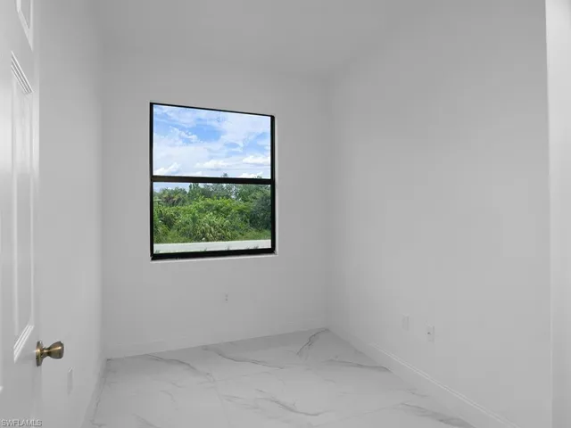 Spare room with light tile patterned floors