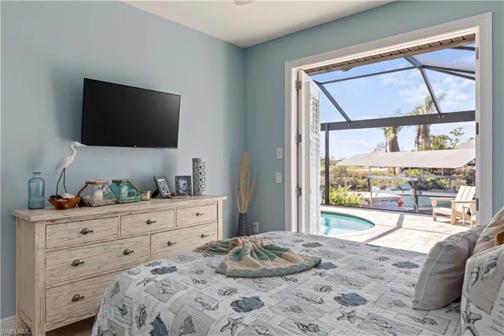 2nd Bedroom featuring access to exterior pool deck with water views!