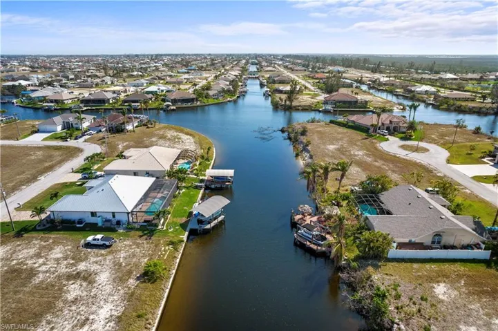 Birds eye view of property with a water view