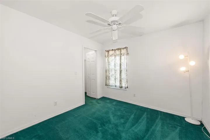 Guest bedroom 3 features a walk in closet with a window view of the front