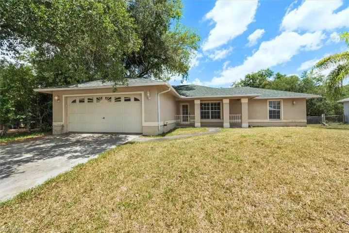 Nice oak trees to shade the driveway and home. Nice sitting porch area on the front as well.