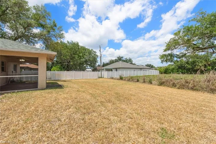 Large backyard with floratam grass. Dry due to water restrictions, but we are almost back to rainy season.