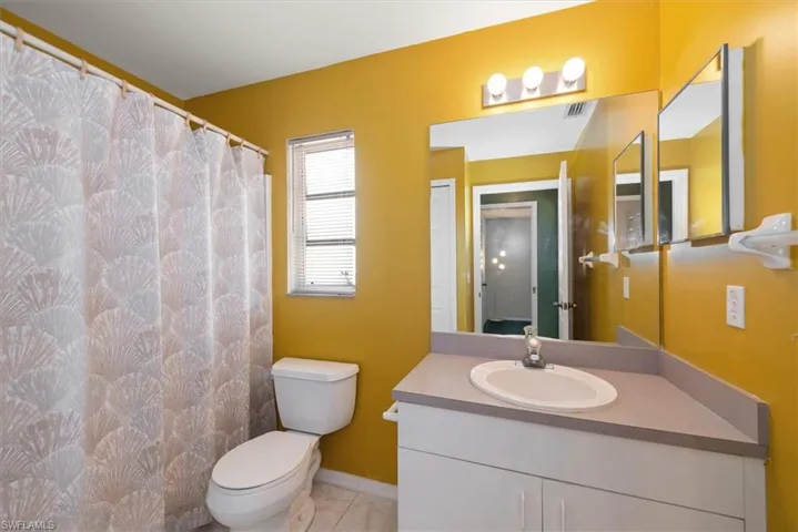 Guest bathroom features a tub shower combo.