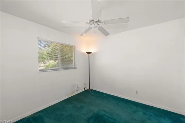 Guest bedroom in the rear has a window with a view of the backyard.