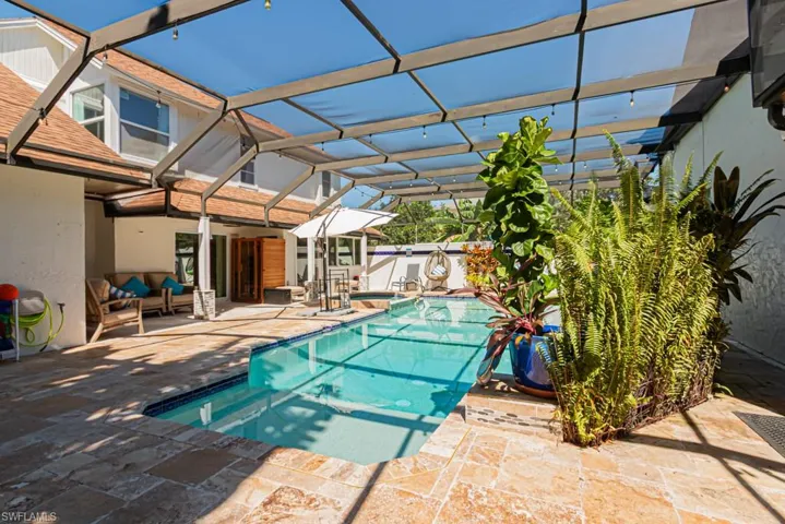 View of swimming pool with a sunroom, a patio, a lanai, and a pool with connected hot tub