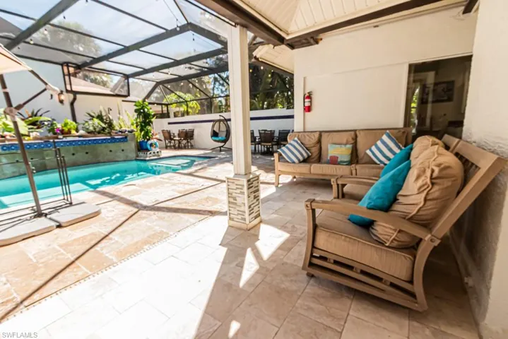 Swimming pool featuring a patio, a lanai, a sunroom, outdoor dining space, and an outdoor hangout area