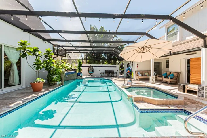 View of pool with a patio area, a pool with connected hot tub, a lanai, and a sunroom