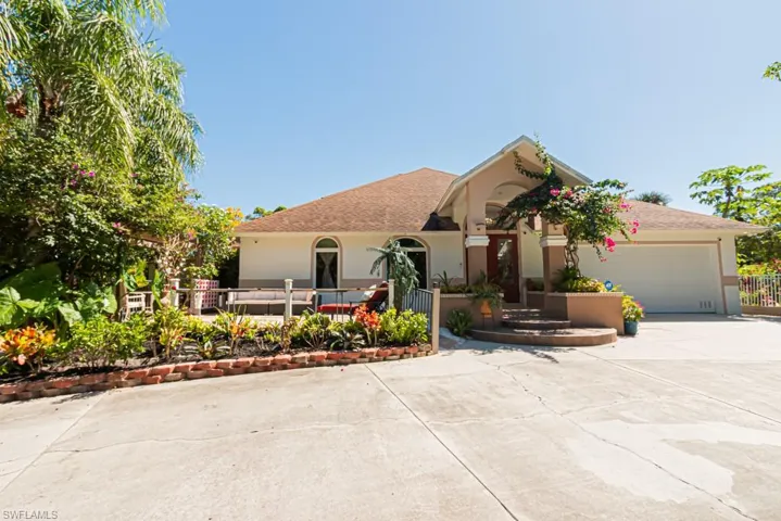 Ranch-style house featuring driveway, an attached garage, stucco siding, and a shingled roof