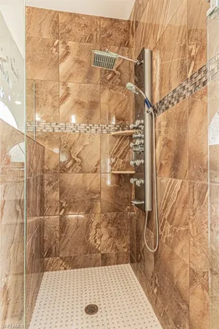 Bathroom featuring tiled shower