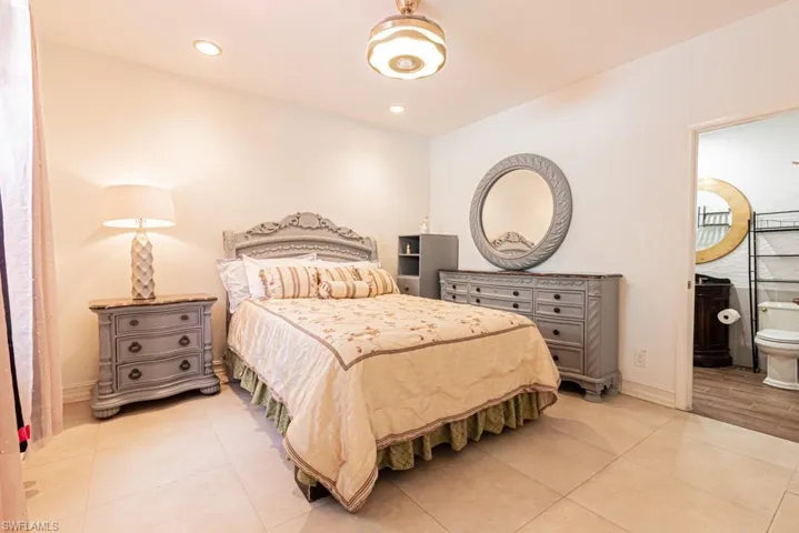 Guest House Bedroom with light tile patterned floors, recessed lighting, and ensuite bathroom