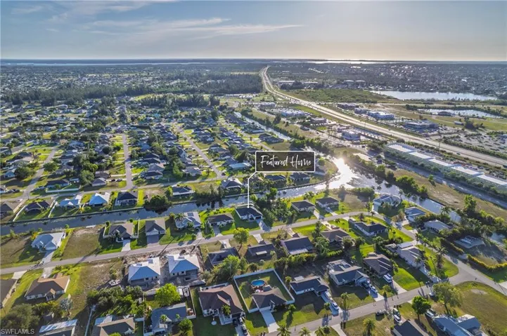 Aerial view of property's location with nearby suburban area