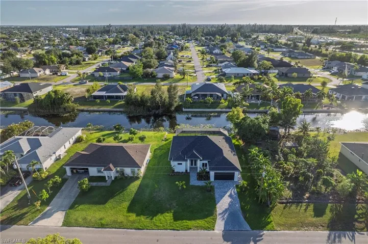 Aerial perspective of suburban area featuring a large body of water