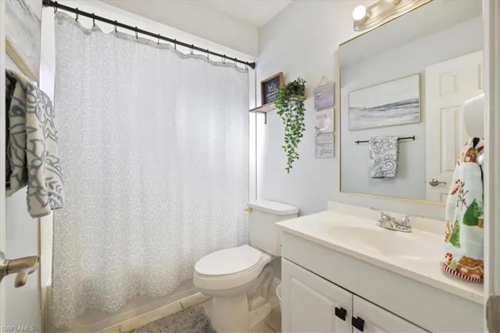 2nd Bathroom featuring vanity, light tile patterned floors, and shower / bath combination with curtain