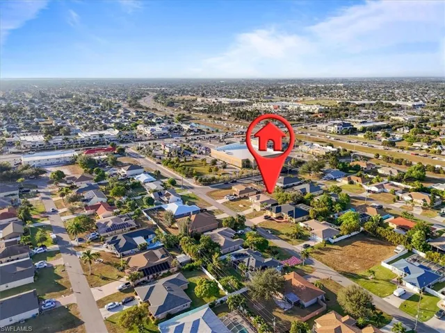 Aerial view of property's location featuring nearby suburban area