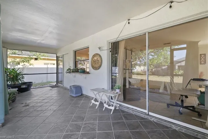Screened and tiled lanai featuring plenty of natural light