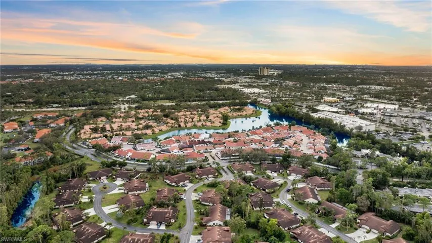 Aerial view at dusk featuring a water view