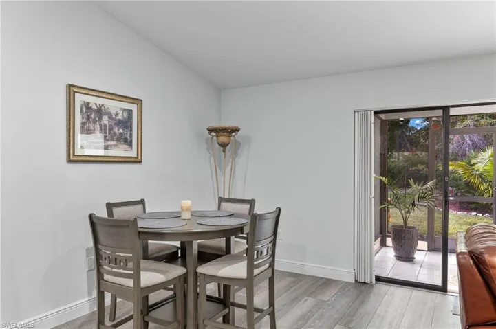 Dining area featuring plenty of natural light, light wood-type flooring, and lofted ceiling