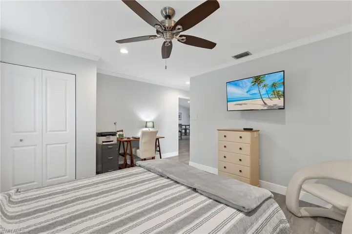 Bedroom with crown molding, a closet, and ceiling fan