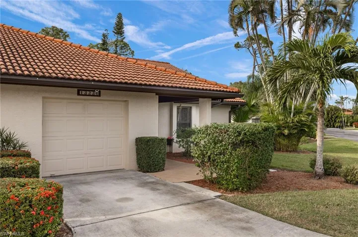 Mediterranean / spanish home with a garage and a front yard