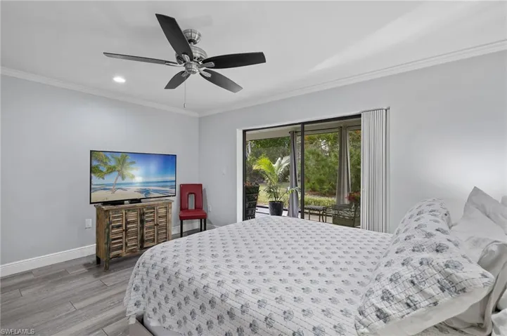 Bedroom with hardwood / wood-style flooring, access to outside, ceiling fan, and crown molding