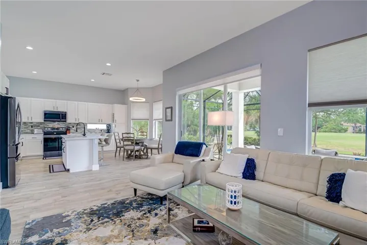 Living room with visible vents, light wood-type flooring, and recessed lighting