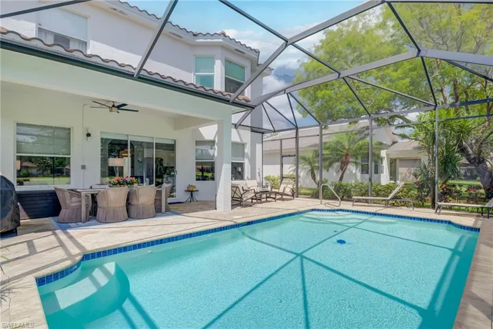 Outdoor pool featuring a ceiling fan, a patio, and glass enclosure