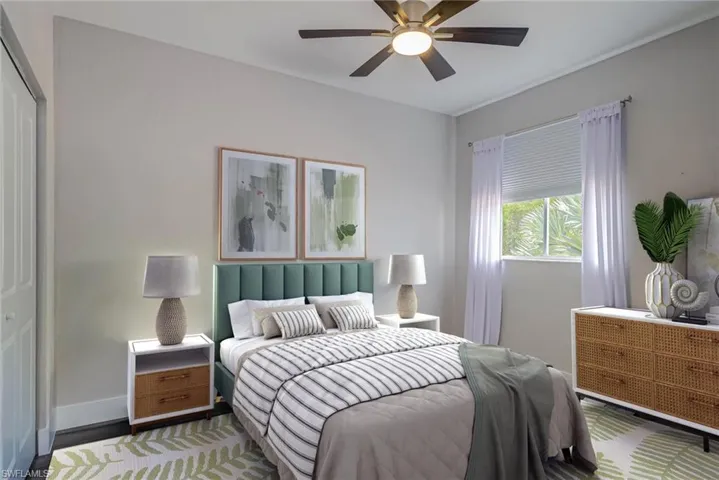 Bedroom with a ceiling fan and baseboards