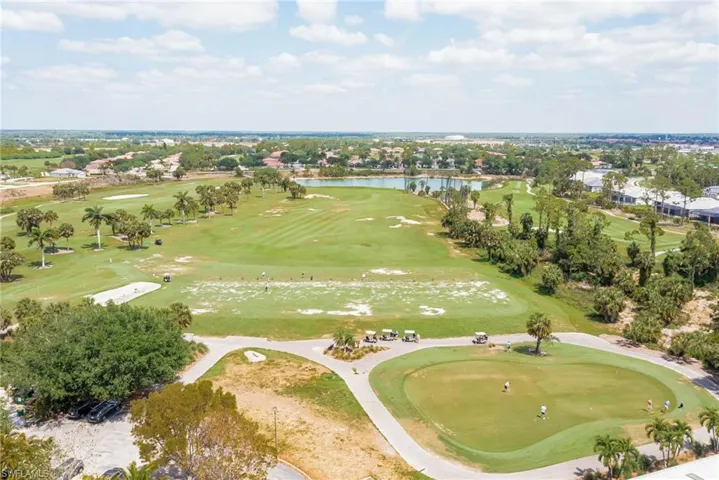 Drone / aerial view with a water view and golf course view