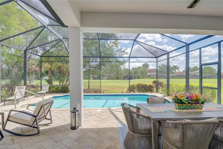 Outdoor pool with a lanai, golf course view, a yard, and a patio area