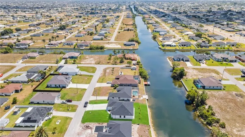 Drone / aerial view with a water view and a residential view