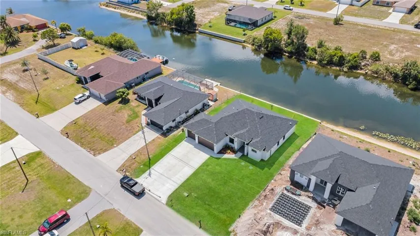 Drone / aerial view with a water view and a residential view